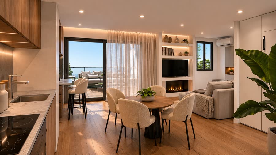 Salón-comedor con cocina abierta y salida a la terraza en un apartamento junto al mar